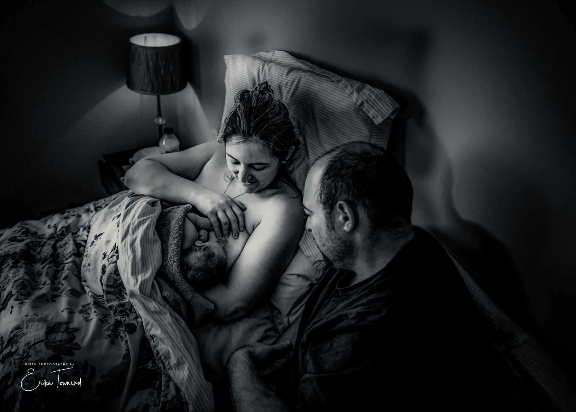 Black and white image of a couple having skin to skin after their homebirth by Erika Townend Birth