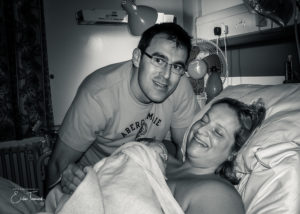 Black and white image of women and husband post birth full of oxytocin